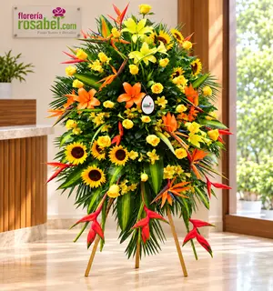 Flores para inauguración en trípode con girasoles, rosas amarillas, lirios, astromelias y flores tropicales